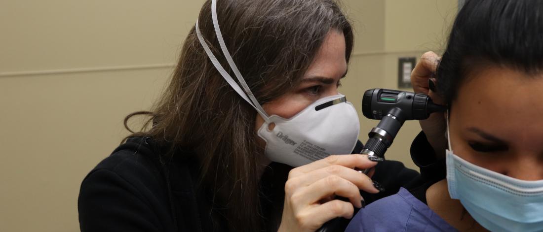 Physician examining a patient's ear.